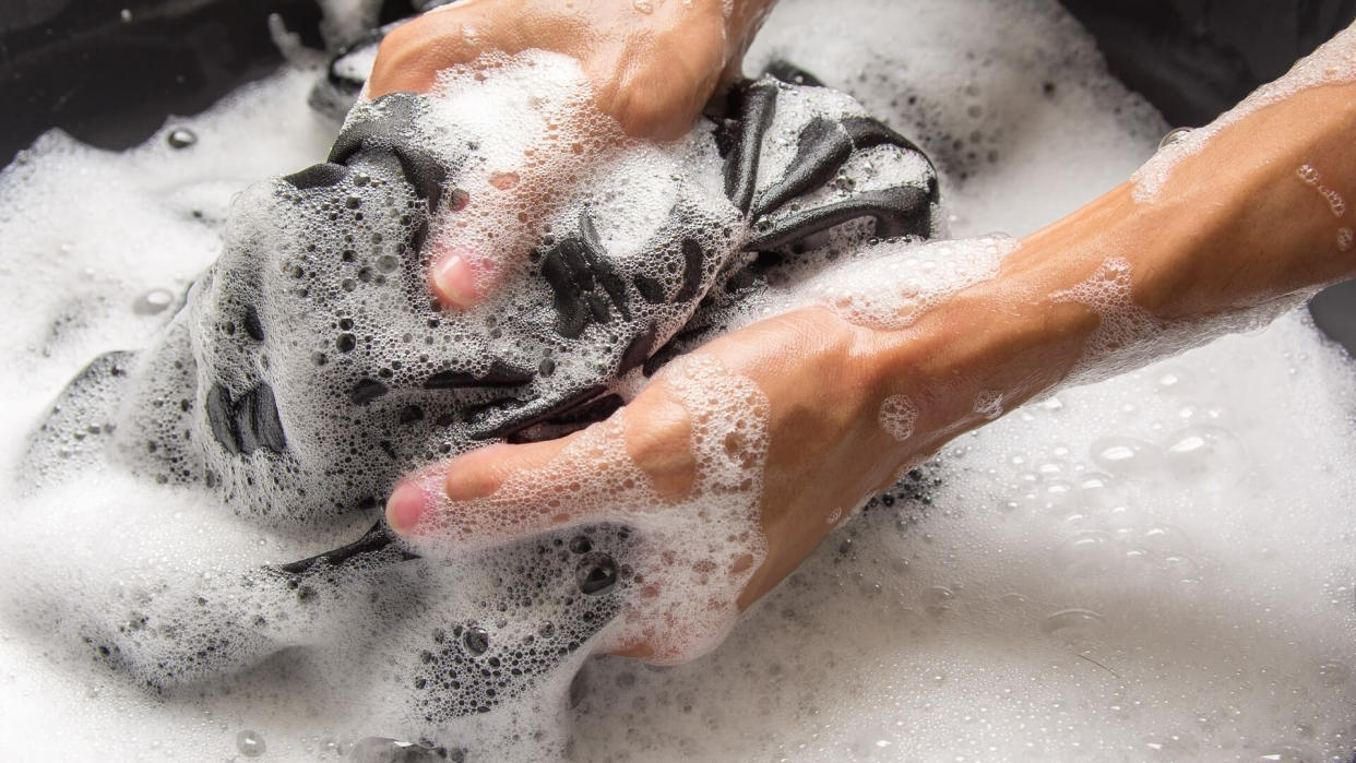 person hand washing laundry