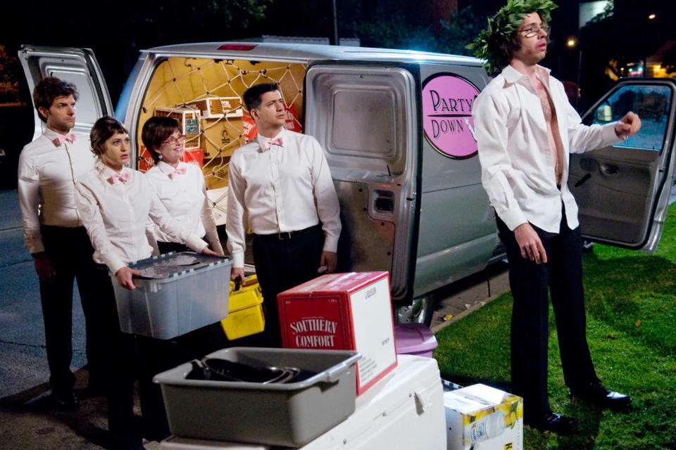 Adam Scott, Lizzy Caplan, Megan Mullally, Ken Marino, and Martin Starr stand outside a catering truck.