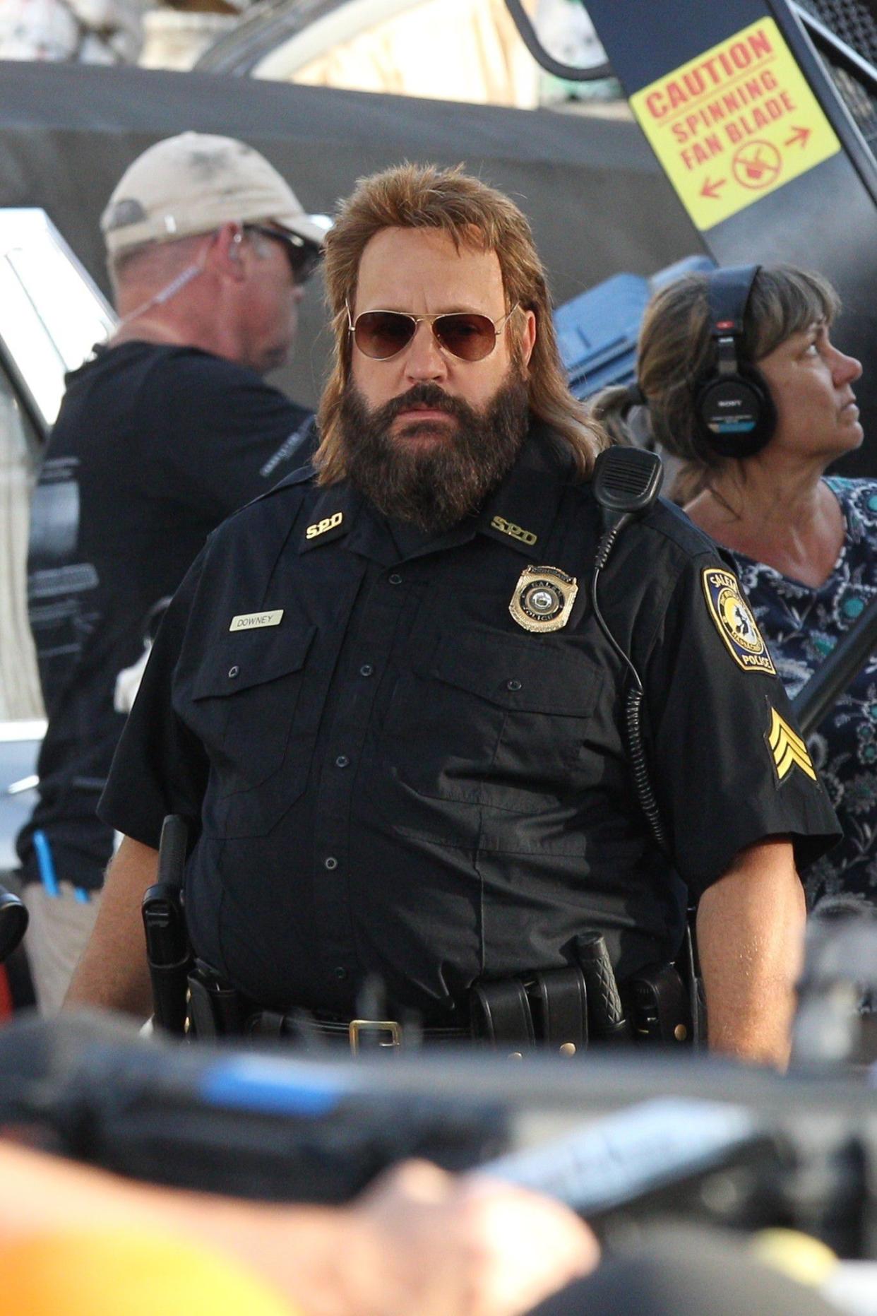 Actor Kevin James looks almost unrecognizable while wearing a serious mullet and police uniform on the set of Netflix and Adam Sandler's latest movie "Hubie Halloween," in Marblehead, MA on July 15, 2019.