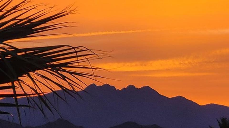 <div>The morning glow of an Arizona sunrise leaks out over the Four Peaks. Thanks to Russ Preban for capturing this shot from Fountain Hills!</div>