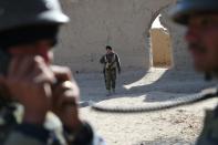 Afghan National Army soldiers patrol the compound of the mosque where Mullah Omar founded the Taliban movement over 20 years ago, in the village of Sangesar