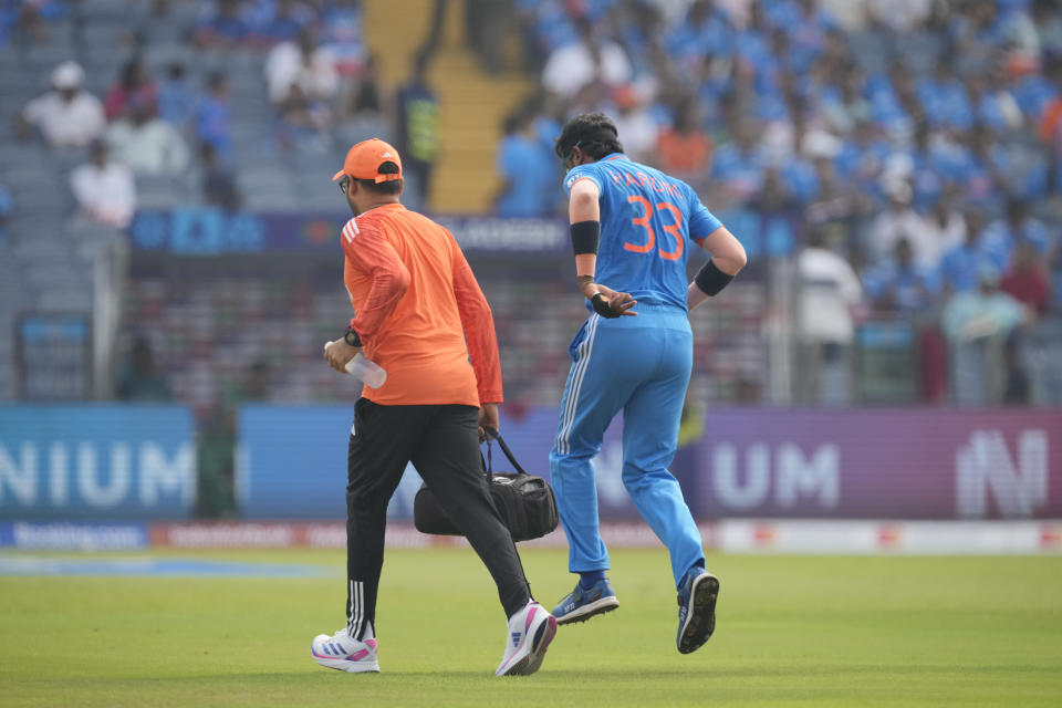 India's Hardik Pandya limps out of the field after an injury during the ICC Men's Cricket World Cup match between India and Bangladesh in Pune, India, Thursday, Oct. 19, 2023. (AP Photo/Anupam Nath)