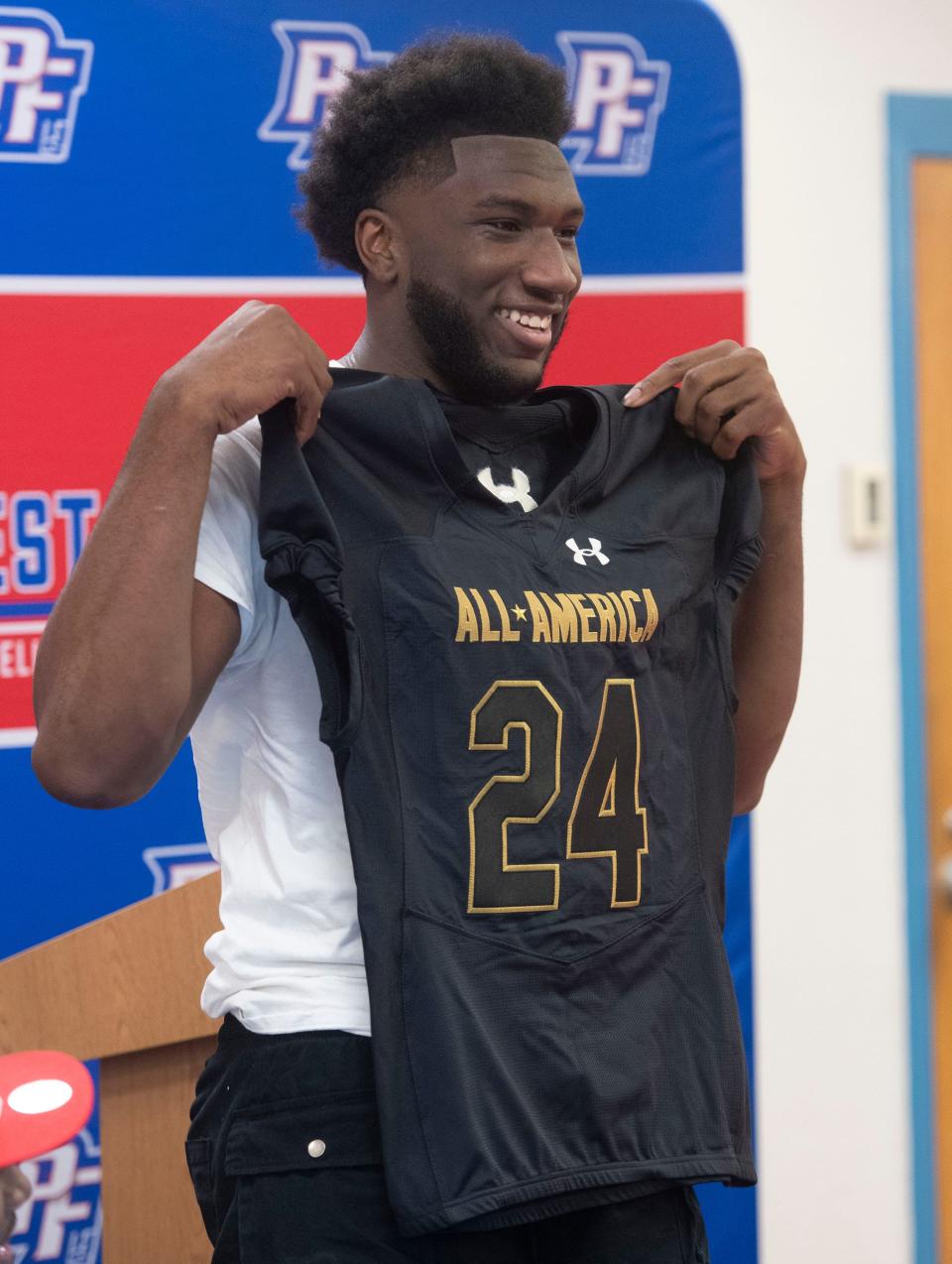 Pine Forest High School football star Jonathan Daniels shows off his Under Armour All-American team jersey during a school ceremony on Monday, November 27, 2023.