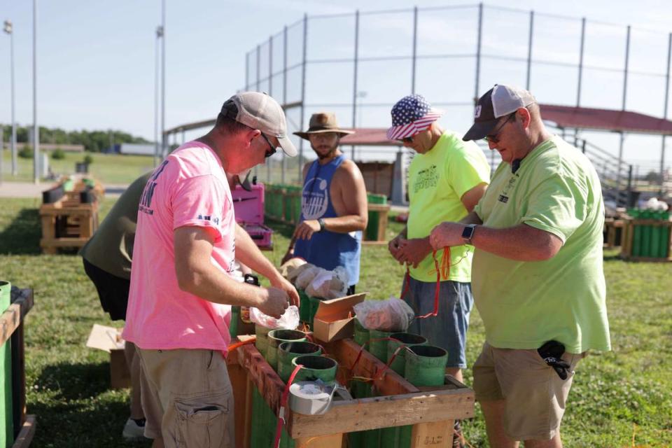 Members of the Pyro Crew prep a mortar rack at the launch site prior to the big show.