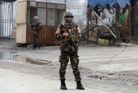 FILE PHOTO: A member of the Afghan security force keeps watch at the site of a suicide bomb attack in Kabul, Afghanistan March 2, 2018. REUTERS/Omar Sobhani/File Photo