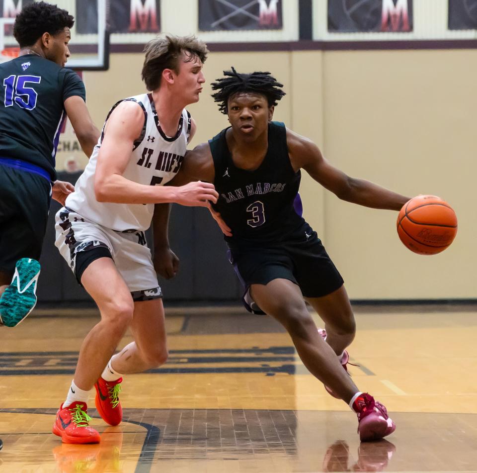 San Marcos Rattlers guard Donavan Riddick (3) dribbles the ball past St. Michaels Crusaders guard Bo Ogden (5) during the first period at the non-district boys basketball game on Tuesday, Jan 2, 2024, at St. Michael's High School - Austin, TX.