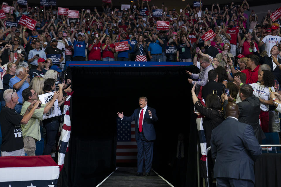 President Donald Trump arrives on stage to speak at a campaign rally at the BOK Center, Saturday, June 20, 2020, in Tulsa, Okla. (AP Photo/Evan Vucci)