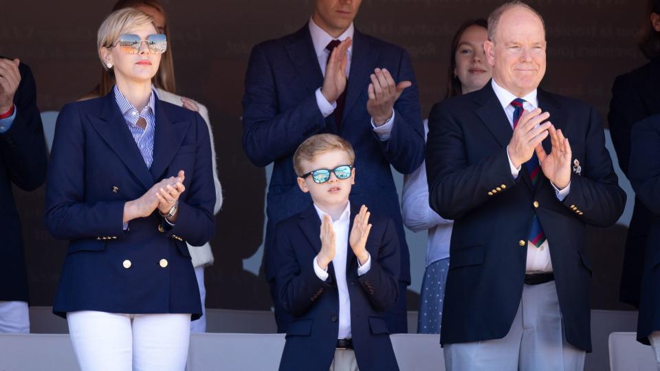 Princess Charlene and Prince Jacques clapping in sunglasses