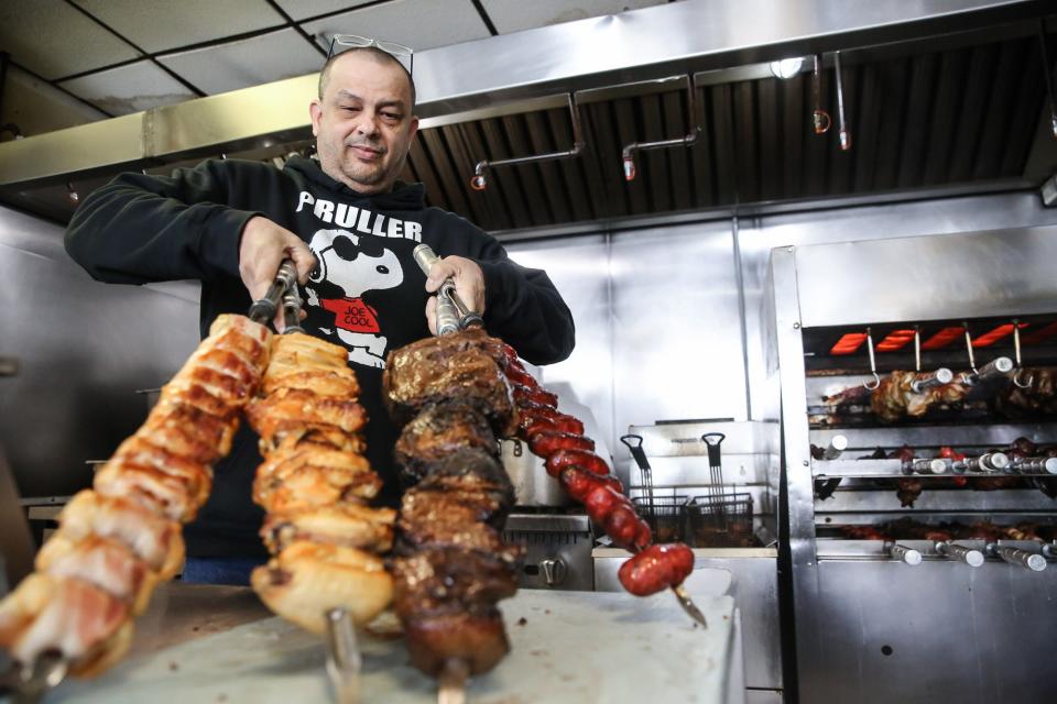 Owner Erich Pruller with some of the meat offerings at  Pruller Restaurant on Lincoln Street in Marlborough, Oct. 16, 2022.