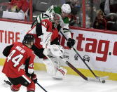 Dallas Stars right wing Denis Gurianov (34) tries to take the puck from Ottawa Senators goaltender Craig Anderson (41) behind the net during the third period of an NHL hockey game Sunday, Feb. 16, 2020, in Ottawa, Ontario. (Justin Tang/The Canadian Press via AP)