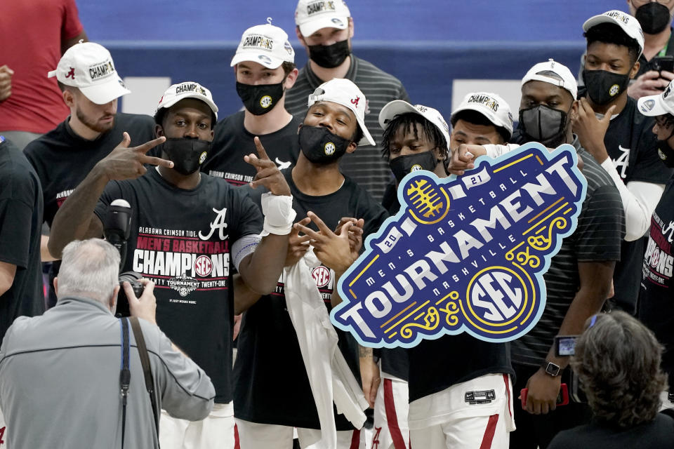 Alabama players celebrate after beating LSU in the championship game of the NCAA college basketball Southeastern Conference Tournament Sunday, March 14, 2021, in Nashville, Tenn. Alabama won 80-79. (AP Photo/Mark Humphrey)