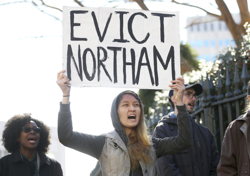 Geraldine Mabagos, of Richmond, holds a sign during a protest in Richmond calling for Governor Ralph Northam to resign on Monday Feb. 4, 2019. Northam has rebuffed widespread calls for his resignation after a racist photo surfaced Friday in his 1984 medical school yearbook page. (Shelby Lum/Richmond Times-Dispatch via AP)