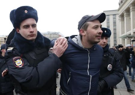 Policemen detain a man while patrolling the city centre in the case of an anti-government protest, which was not sanctioned by the authorities, in central Moscow, Russia, April 2, 2017. REUTERS/Maxim Shemetov