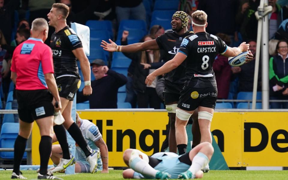 Exhausted Harlequins players collapse with despair following Tshiunza's last-minute try which handed Exeter the win - David Davies/PA