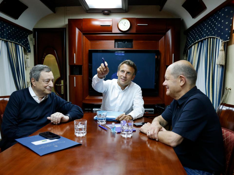 French President Emmanuel Macron, center, German Chancellor Olaf Scholz, right, and Italian Prime Minister Mario Draghi travel on board a train bound to Kyiv after departing from Poland in June.