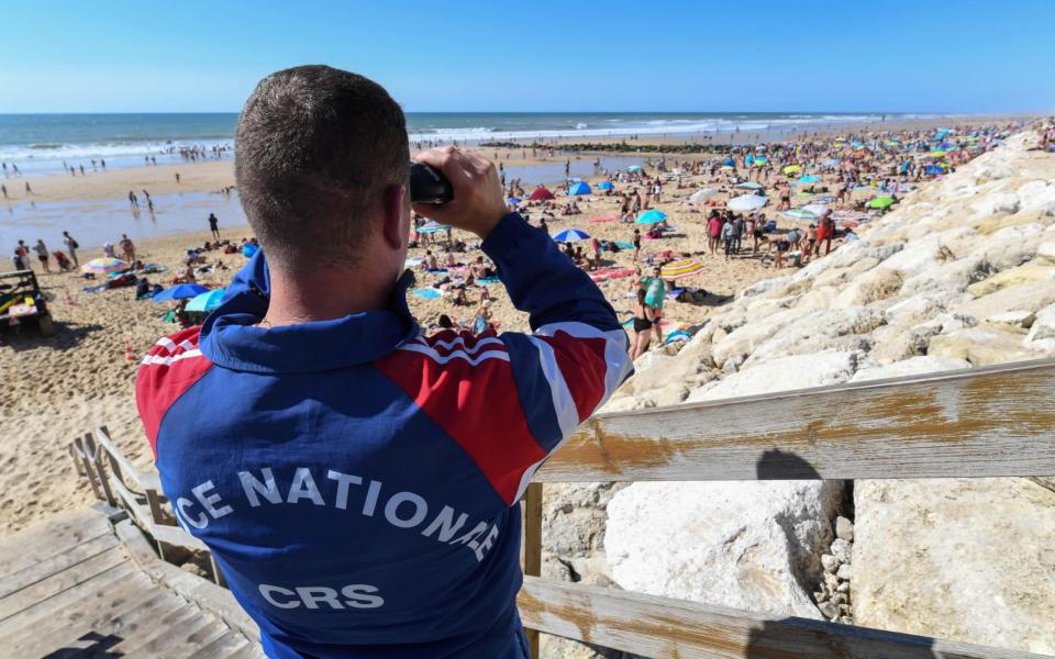 Strapping riot police have been standing in as lifeguards for decades - AFP