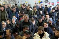 In this photo taken from video released by Kazakhstan's Presidential Press Office, people listens to Kazakh President Kassym-Jomart Tokayev as he expresses condolences to the families and friends of the miners who died in the fire in Karaganda, Kazakhstan, Saturday, Oct. 28, 2023. A coal mine fire in central Kazakhstan has killed at least 21 workers while another 25 remained unaccounted for, the operating company ArcelorMittal Temirtau said in a statement. ArcelorMittal Temirtau is the local representative for Luxembourg-based multinational ArcelorMittal, the world's second-largest steel producer. (Kazakhstan's Presidential Press Office via AP)