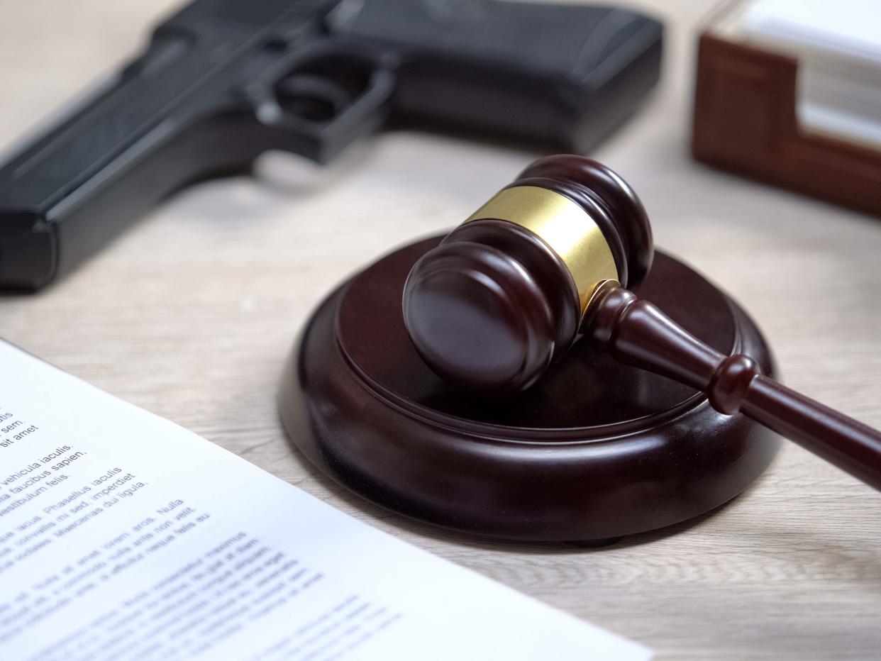 Gun and gavel on table