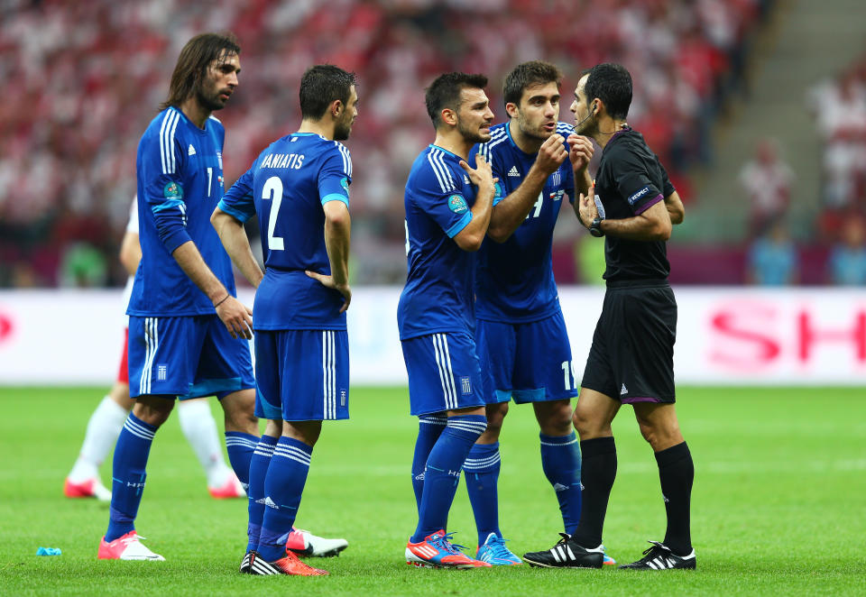 WARSAW, POLAND - JUNE 08: Sokratis Papastathopoulos of Greece appeals to the Referee Carlos Velasco Carballo before he is sent off after receiving a second yellow card during the UEFA EURO 2012 group A match between Poland and Greece at The National Stadium on June 8, 2012 in Warsaw, Poland. (Photo by Michael Steele/Getty Images)