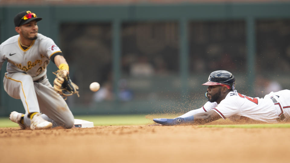 Pittsburgh Pirates second baseman Tucupita Marcano, left, waits for the ball to tag out Atlanta Braves' Michael Harris II, right, in the fifth inning of a baseball game Saturday, June 11, 2022, in Atlanta. (AP Photo/Hakim Wright Sr.)
