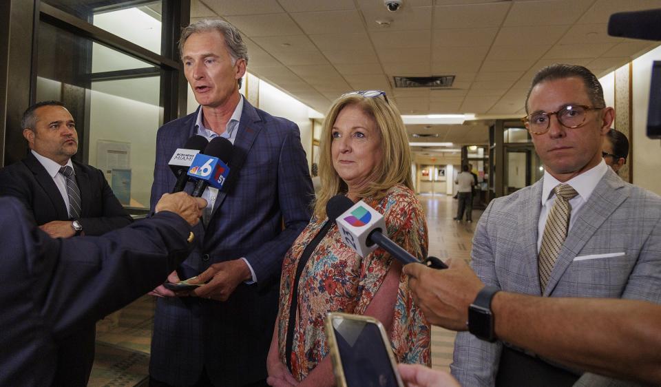 Kim and Deborah Clenney, the parents of the OnlyFans model Courtney Clenney, talk to the press, flanked by defense attorneys Frank Prieto, far left, and Jude M. Faccidomo, after a hearing in front of Judge Laura Shearon Cruz, where the computer hacking charges against themselves and their daughter were dismissed at the Gerstein Justice Building, Thursday, July 11, 2024, in Miami. Courtney Clenney is accused of stabbing to death her boyfriend in a Miami condo in 2022. The murder charge has not been dropped. (Pedro Portal/Miami Herald via AP)