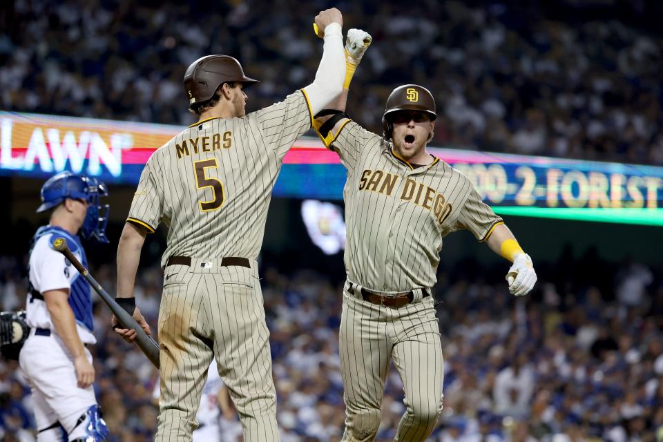 San Diego Padres second baseman Jake Cronenworth celebrates with right fielder Wil Myers after hitting a home run in the eighth inning of Game 2 against the Los Angeles Dodgers.