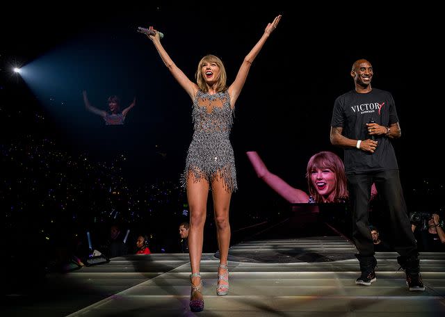 <p>Christopher Polk/Getty </p> Taylor Swift (L) and NBA player Kobe Bryant speak onstage during The 1989 World Tour Live