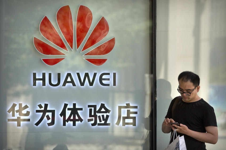 A man uses his smartphone outside of a shop selling Huawei products at a shopping mall in Beijing, Wednesday, May 29, 2019. Chinese tech giant Huawei filed a motion in U.S. court Wednesday challenging the constitutionality of a law that limits its sales of telecom equipment, the latest action in an ongoing clash with the U.S. government. (AP Photo/Mark Schiefelbein)