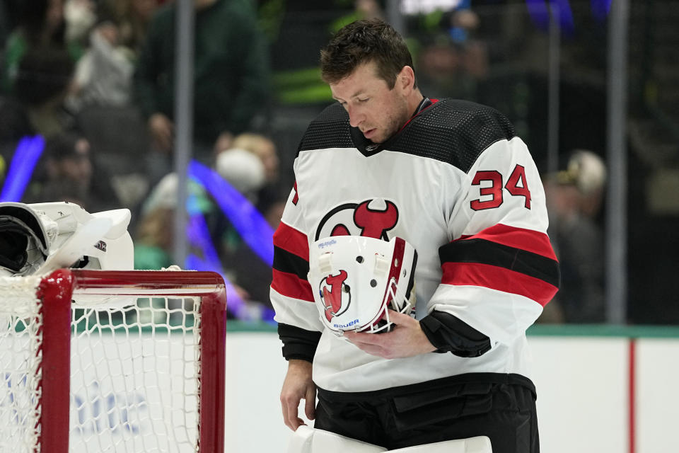 New Jersey Devils goaltender Jake Allen prepares for the start of the first period of an NHL hockey game against the Dallas Stars in Dallas, Thursday, March 14, 2024. (AP Photo/Tony Gutierrez)