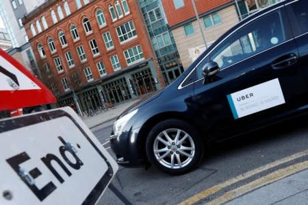 FILE PHOTO: An Uber taxi is driven away from New Street Railway Station in Birmingham, Britain February 5, 2018.  REUTERS/Darren Staples