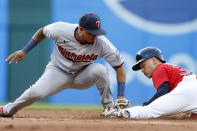 Cleveland Guardians' Steven Kwan, right, steals second base as Minnesota Twins second baseman Luis Arraez attempts a tag during the third inning of a baseball game Wednesday, June 29, 2022, in Cleveland. (AP Photo/Ron Schwane)
