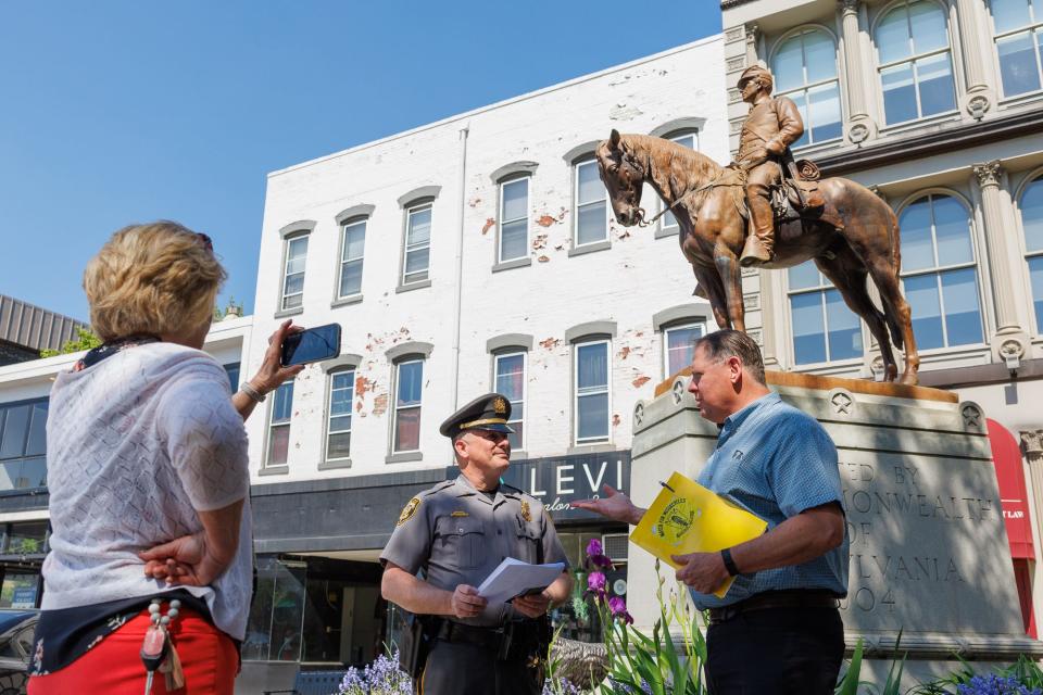 Hanover Borough Police Department Lt. Joseph Bunty, center, speaks with Jeff Bowman, law enforcement liaison from the Highway Safety Network, during a PennDOT Facebook Live event focused on pedestrian safety, Monday, April 29, 2024, in downtown Hanover Borough.