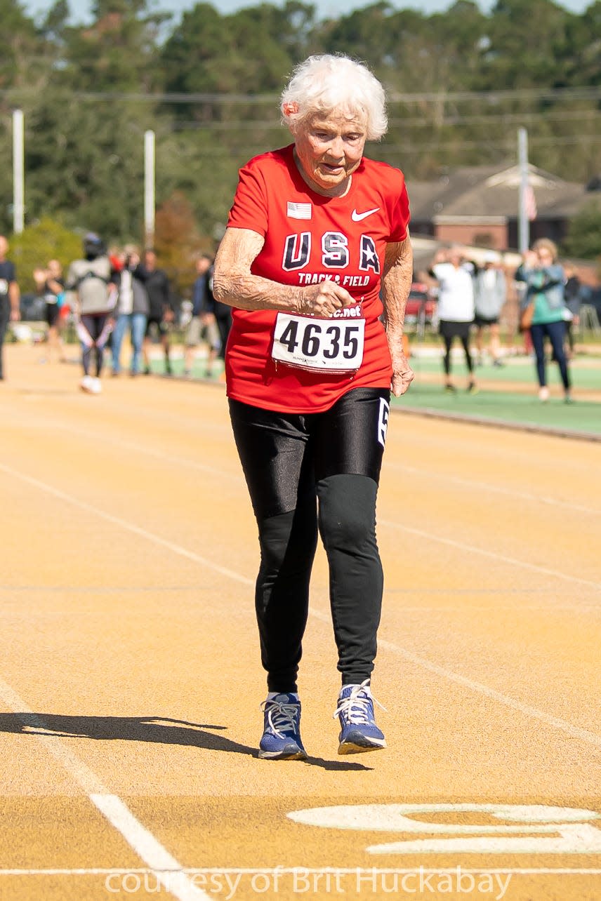 Julia Hawkins crossing the finish line.