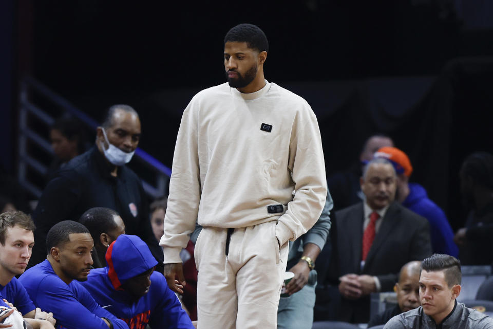 Los Angeles Clippers guard Paul George, center, walks to the bench during the second half of an NBA basketball game against the Cleveland Cavaliers, Sunday, Jan. 29, 2023, in Cleveland. George did not play against the Cavaliers. (AP Photo/Ron Schwane)