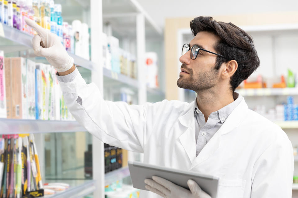 a pharmacist looking at different medication