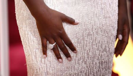 Actress Lupita Nyong'o wears a Calvin Klein gown and Chopard diamonds as she arrives at the 87th Academy Awards in Hollywood, California in this February 22, 2015 file photo. REUTERS/Lucas Jackson/Files