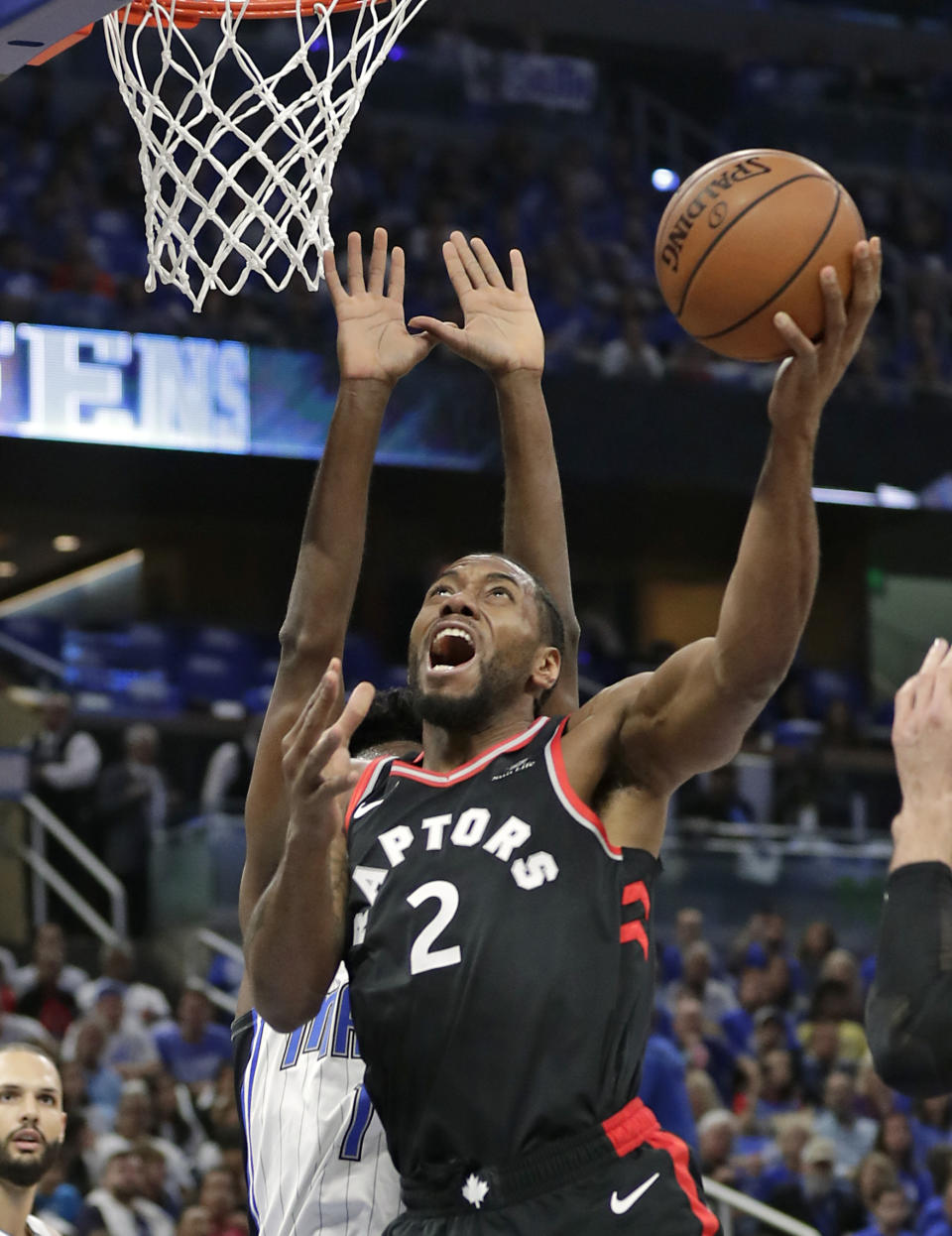Toronto Raptors' Kawhi Leonard (2) makes a shot in front of Orlando Magic's Jonathan Isaac during the first half in Game 4 of a first-round NBA basketball playoff series, Sunday, April 21, 2019, in Orlando, Fla. (AP Photo/John Raoux)