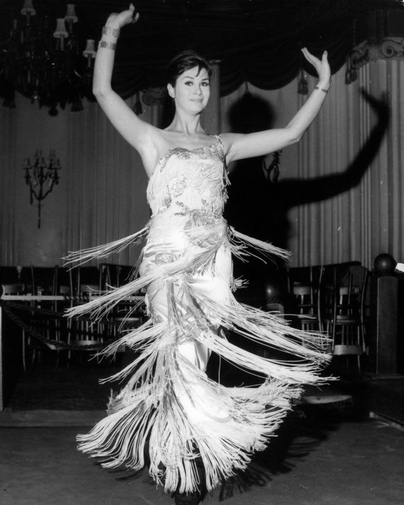 April Ashley on stage with her song and dance act at the Astor Club in London, 1962.