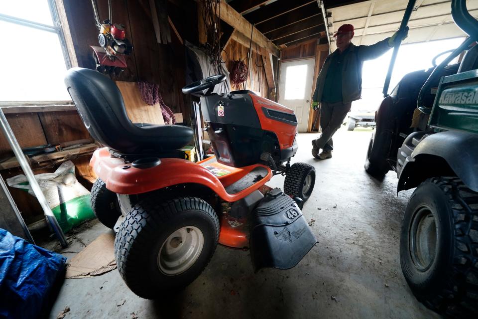 Trailer park owner Ed Smith looks at one of Geoffrey Holt's riding mowers at Stearns Park, Wednesday, Nov. 15, 2023, in Hinsdale, N.H.