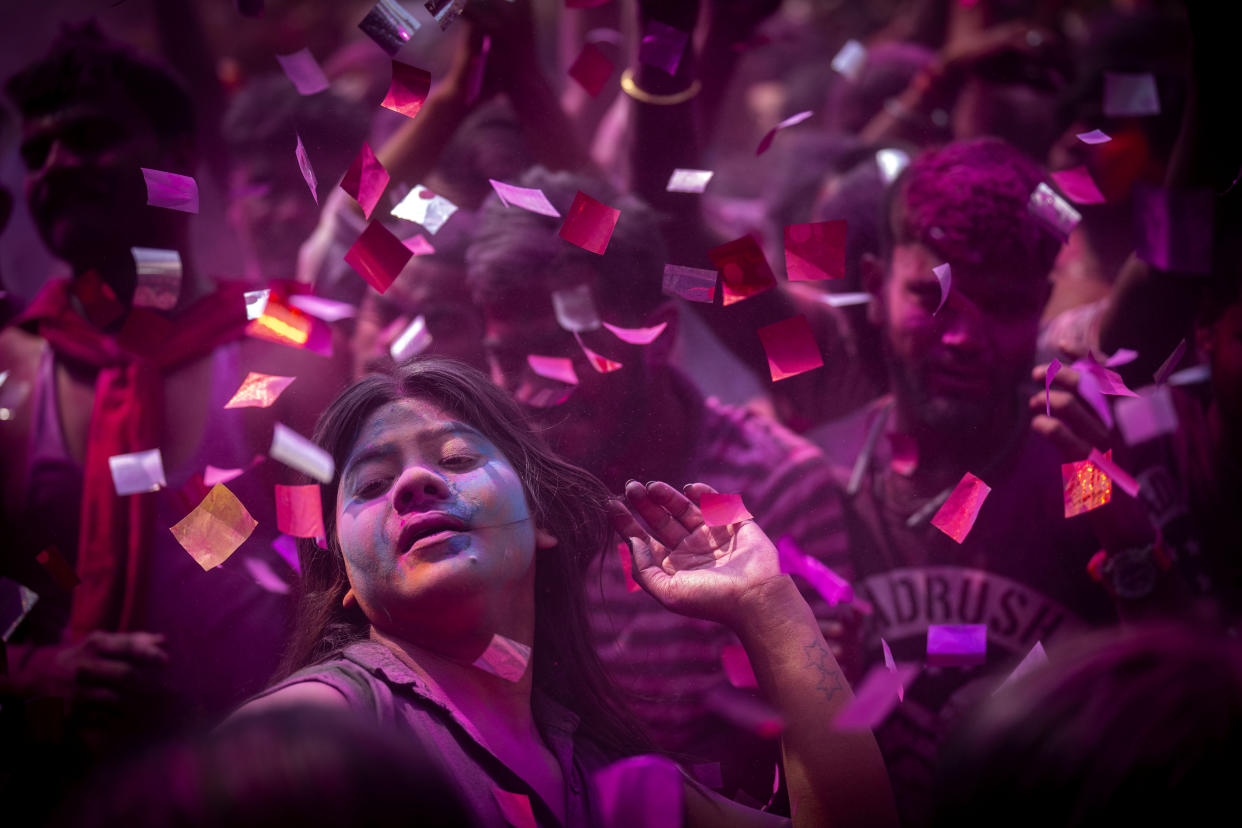 People celebrate Holi, the festival of colors on a street in Guwahati, India, Wednesday, March 8, 2023.Millions of Indians on Wednesday celebrated the ''Holi" festival, dancing to the beat of drums and smearing each other with green, yellow and red colors and exchanging sweets in homes, parks and streets. Free from mask and other COVID-19 restrictions after two years, they also drenched each other with colored water. (AP Photo/Anupam Nath)