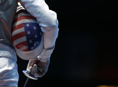 Miles Chamley-Watson of the U.S. holds his mask as he competes against Egypt's Alaaeldin Abouelkassem during their men's individual foil round of 32 fencing competition at the ExCel venue at the London 2012 Olympic Games July 31, 2012. REUTERS/Damir Sagolj