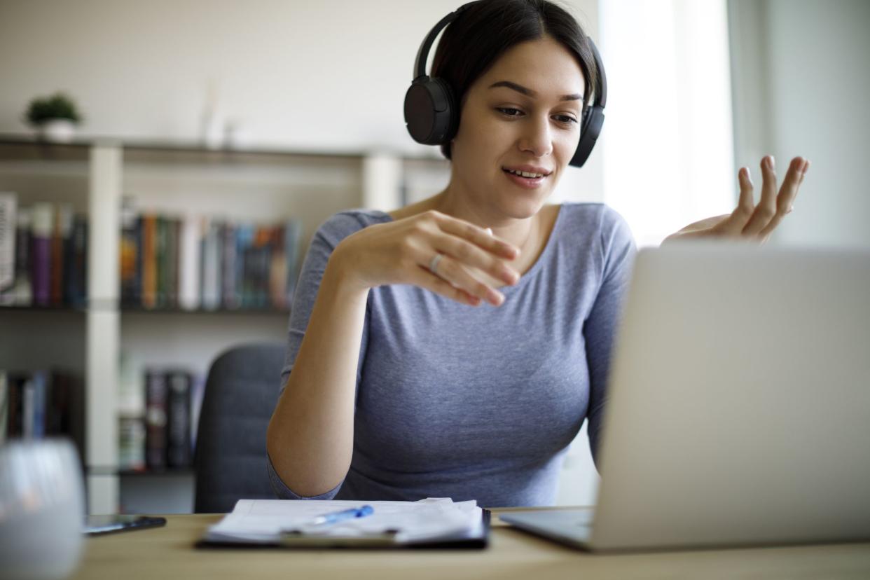 Young woman having video call on laptop computer at home