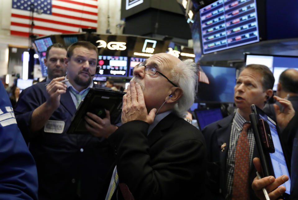 Peter Tuchman, center, works with fellow traders on the floor of the New York Stock Exchange, Friday, Oct. 26, 2018. Stocks are opening broadly lower on Wall Street, a day after a massive surge, as a number of big companies reported disappointing results. (AP Photo/Richard Drew)