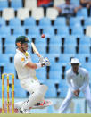 Australia's batsman David Warner, left, avoids a bouncer as South Africa's Alviro Petersen, right, watches on the third day of their their cricket test match at Centurion Park in Pretoria, South Africa, Friday, Feb. 14, 2014. (AP Photo/ Themba Hadebe)