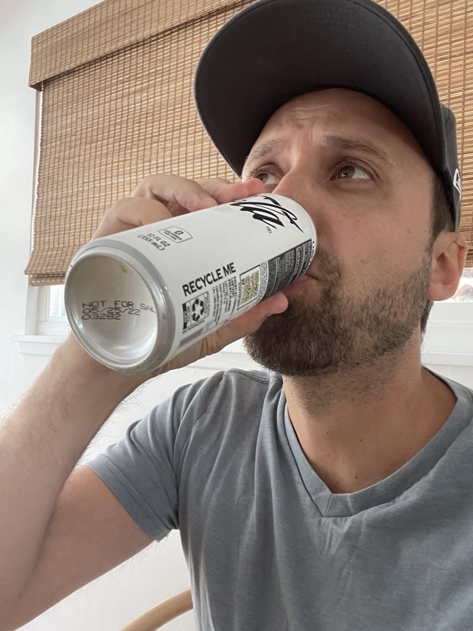 The author taking a sip of the soda from the can