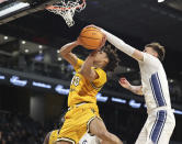 Long Beach State guard AJ George (10) is blocked by UC Davis guard Kane Milling under the basket during the first half of an NCAA college basketball game in the championship of the Big West Conference men's tournament Saturday, March 16, 2024, in Henderson, Nev. (AP Photo/Ronda Churchill)