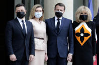 French President Emmanuel Macron, second right, and his wife Brigitte Macron, right, pose with Ukrainian President Volodymyr Zelenskyy, left, and Olena Zelenska before a working lunch at the Elysee palace in Paris, Friday, April 16, 2021. Ukrainian President Volodymyr Zelenskyy is holding talks with French President Emmanuel Macron and German Chancellor Angela Merkel amid growing tensions with Russia, which has deployed troops at the border with the country. (AP Photo/Lewis Joly)