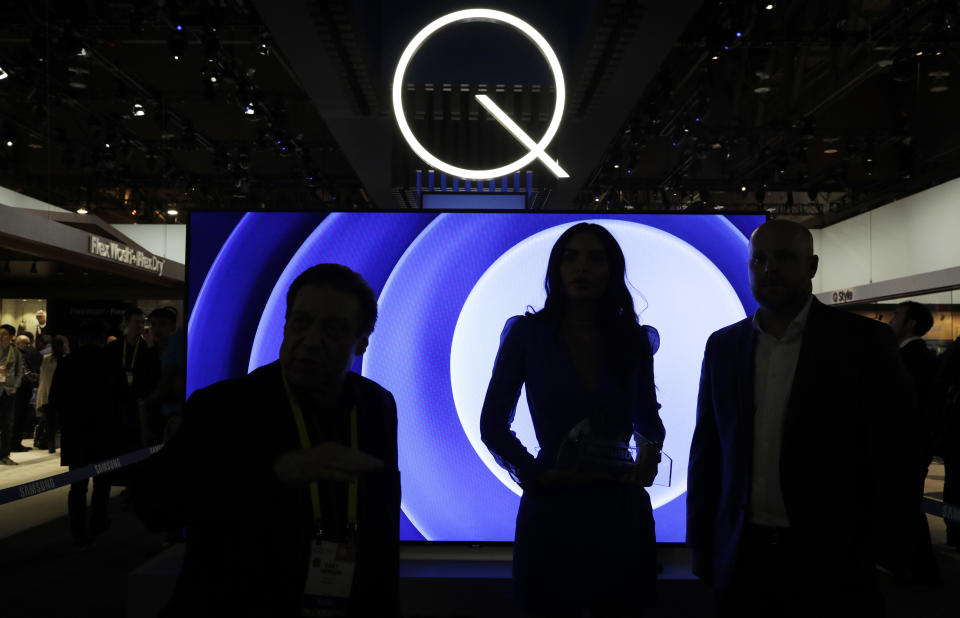 FILE- In this Jan. 6, 2017, file photo attendees stand in front of a QLED TV at the Samsung booth during CES International in Las Vegas. Critics have been on the case of one of the tech industry’s largest trade shows for not including enough female speakers. That seems to be changing this year at CES, the huge consumer-electronics show in Las Vegas. Last year, CES initially had no female keynote speakers, and drew heavy criticism. This year, activists have given it an award for the gender and racial balance of its speaker lineup. (AP Photo/John Locher, File)