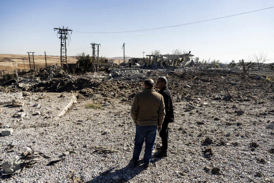 FILE -- People look at a site damaged by Turkish airstrikes that hit an electricity station in the village of Taql Baql, in Hasakeh province, Syria, Sunday, Nov. 20, 2022. Turkish airstrikes on northern Syria over the weekend that killed and wounded a number of Syrian soldiers could pose a setback to the recent move toward a rapprochement between the two countries after 11 years of tension and hostility. (AP Photo/Baderkhan Ahmad, File)