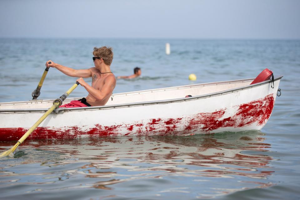 A lifeguard rows a boat at Bradford Beach in July 2019.